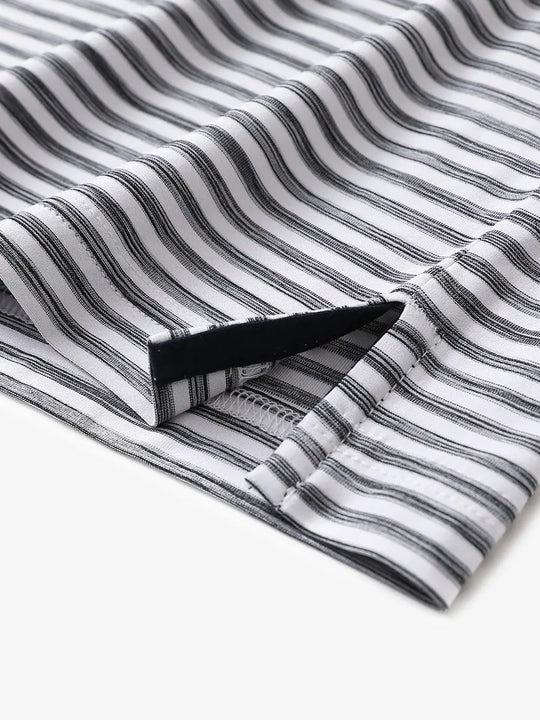 Close-up of hem slit detail on BLACK WHITE Unique Watercolour Stripe Polo