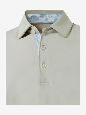 Flat lay of the folded oyster gray everyday classic solid polo, showcasing the neat silhouette and solid color design