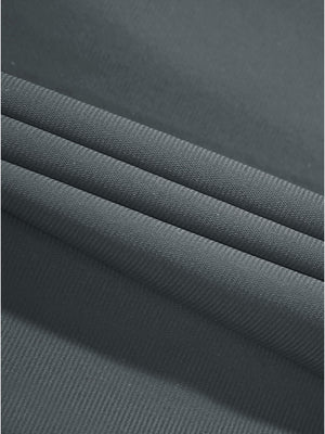Close-up texture of dark grey women's regular fit stretchy golf pants fabric showing detailed stretchy material and weave.