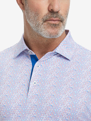 Close-up from nose to chest, showing collar and fabric pattern detail of the colourful hexagon polo shirt.