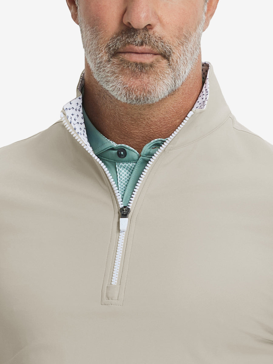 Close-up from nose to chest, showing collar and zipper detail of the khaki light golf pullover.