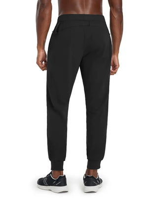 Back lower body view of model wearing BLACK Performance Tapered Sports Joggers