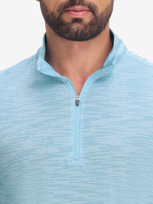 Front view from nose to chest of model wearing misty blue featherweight midlayer quarter zip pullover