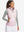 Front upper body of model wearing women's lightweight slim-fit puffer vest, sleek fit in light pink