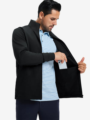 Model wearing water-resistant zip up golf jacket, black, front upper-body with one hand in pocket.