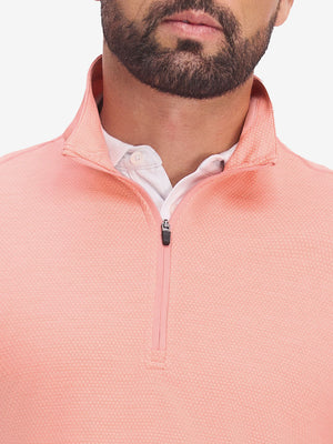 Front view from nose to chest of model wearing orange red grid featherweight midlayer quarter zip pullover