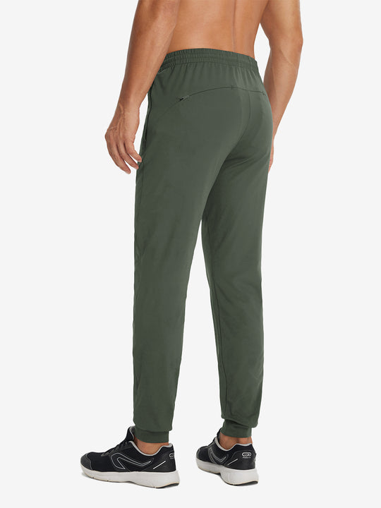 Back lower-body view showing lightweight traning track pants on model in olive green.