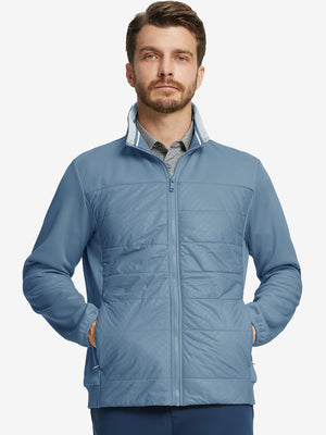Front view of model with both hands in side pockets, wearing Golf Fleece Winter Jacket in Shadow Blue.