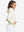 Model with one hand in side pocket wearing women's lightweight hoodies pullover in cream.