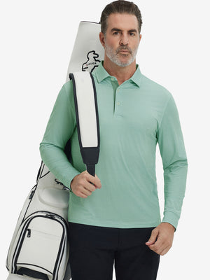 Model carrying golf bag, styled in green plant lightweight print long sleeve polo, sleek golf outfit.