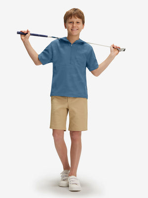 Full-body shot of model holding a golf club in grey blue water-resistant short sleeve q-zip hoodie for boys