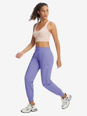 Full-body front view of model wearing women's stretch fleece lined water resistant joggers in lavender.