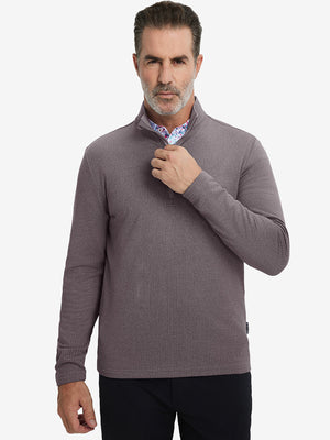 Model grabbing half-zip collar, wearing casual fleece lined quarter zip pullover in drak red.