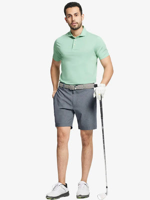 Full body front view of model wearing NAVY 7 Inch Heather Performance Golf Shorts, holding a golf club