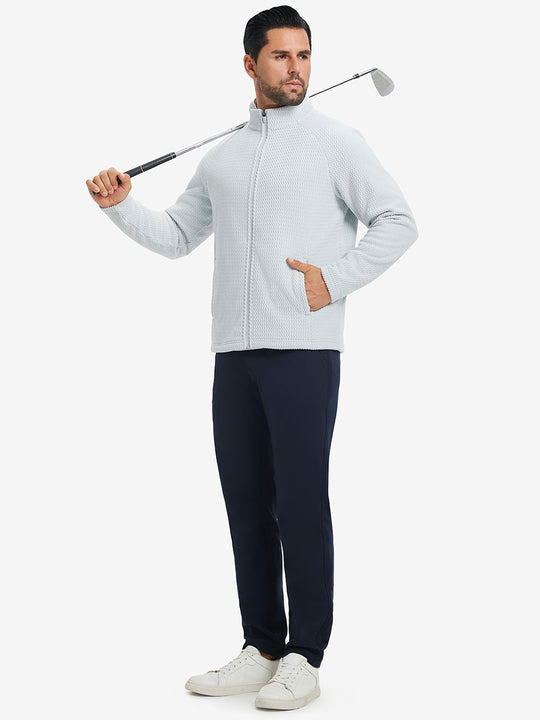 Model in dark blue top holding golf club on shoulder wearing lightweight moisture wicking dress pants in navy.