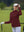 The model is wearing Women's Water-Resistant Stretch Fleece Lined Jacket wine on the golf course.