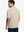 Back half-body view of model in LIGHT KHAKI HEATHER Premium Stretch Heather Polo.