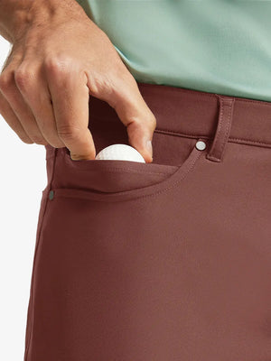 CRANBERRY 4-way Stretch Performance Solid Shorts, front pocket holding golf ball detail, 7 Inch