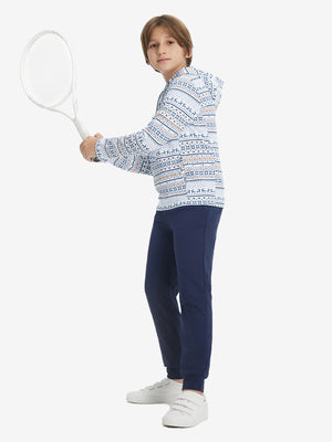 A full-body shot of a model wearing a youth full print stylish hoodie pullover in christmas snowflake.