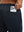 Close-up of iPhone partly inside pocket of navy soft sweatpants with 4 zipper pockets