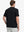 Back half-body view wearing Everyday Collarless Jersey Shirt in Black.