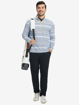 Full-body shot of model holding golf club, dressed in full print quarter zip pullover in christmas snowflake.