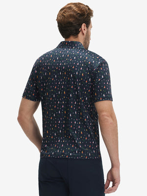 Back half-body view of model wearing the colorful sailboat 4 way stretch print collared polo shirt, highlighting the rear silhouette