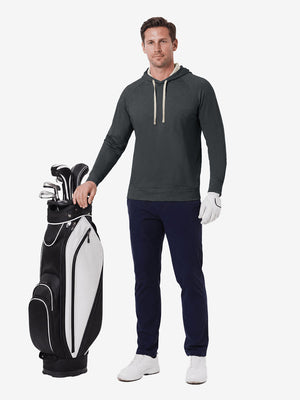 Full body model holding golf gear outdoors, heather midlayer golf hoodies in black heather