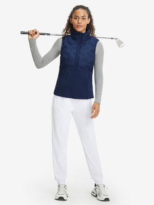 Model holding golf club full body, women's lightweight slim-fit puffer vest styled in sporty navy