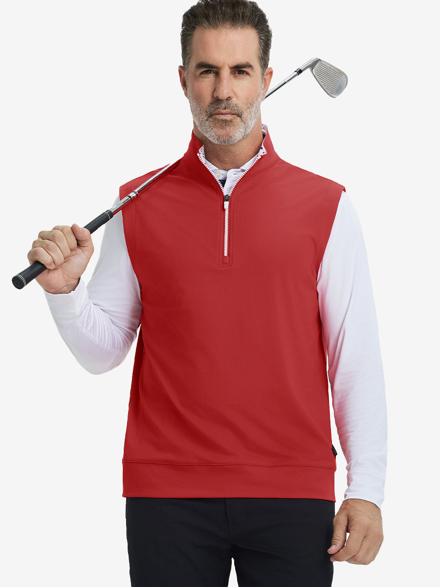Model holding golf club, wearing print collar quarter zip golf vest in red, upper body view.