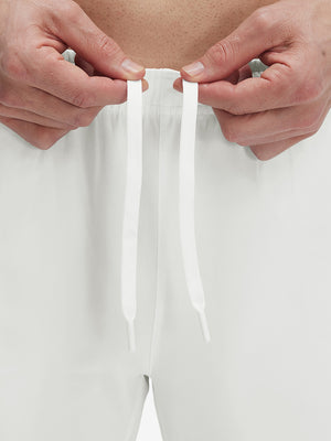 Close-up of elastic waistband on white superion softness mesh joggers with zipper pockets