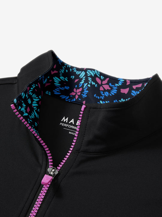 Zipper and inner pattern detail of the print collar quarter zip golf vest in black, highlighting design.