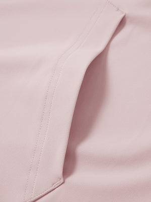 Close-up of single pocket detail on youth long sleeve hoodied with kangaroo pocket in light pink, showing stitching.