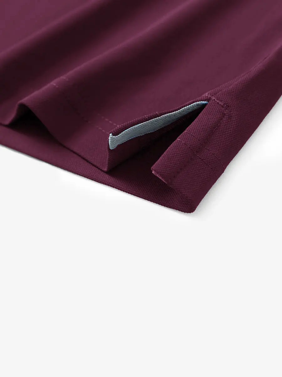 Detail shot of hem opening on BORDEAUX RED Ventilated Pique Performance Polo