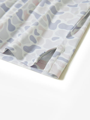 Hem slit detail of the brown & gray camo lightweight print long sleeve polo, showing fine stitching and finish.