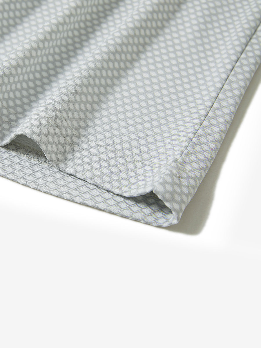 Hem detail of jacquard quarter zip pullover in light grey, focusing on stitching and side vent finish.