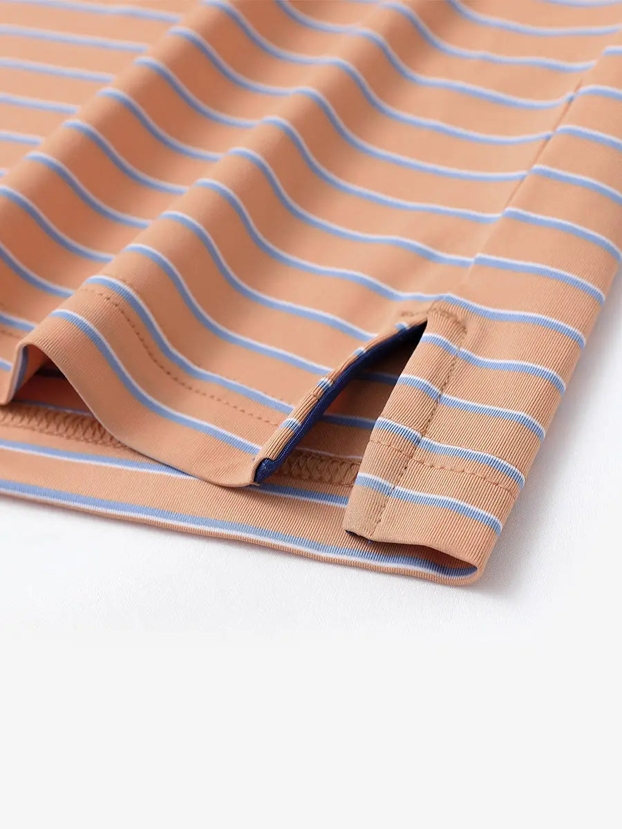 Hem slit detail of ORANGE/SKY BLUE STRIPE Youth Performance Golf Polo highlighting stitching and finish.