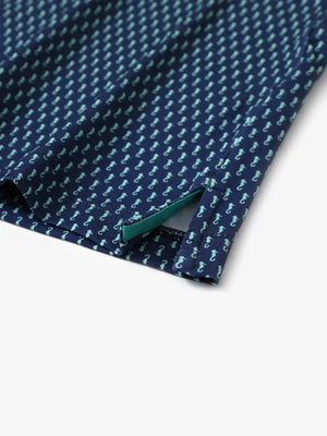 Detailed close-up of side hem slit on GREEN SEAHORSE Performance Print Boys Golf Polo for comfort