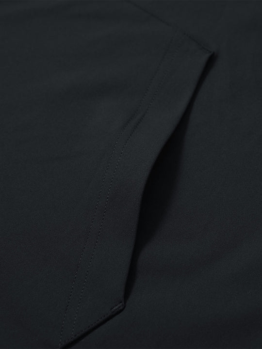 Close-up of single pocket detail on youth long sleeve hoodied with kangaroo pocket in black, showing stitching.