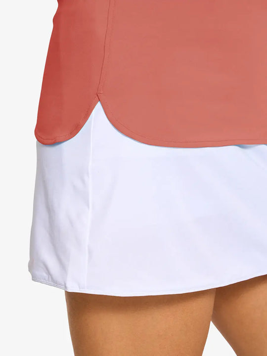 Detail shot of side hem opening on CORAL PINK Women's Performance Solid Polo