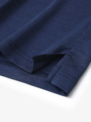 Close-up of hem slit detail on DARK BLUE HEATHER Ventilated Heather Jacquard Polo
