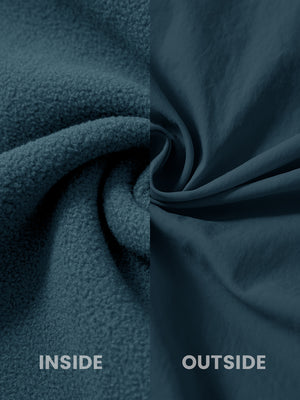 Close-up of the inside-out fabric of the reversible fleece jacket with 5 pockets in dark blue.