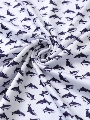 Close-up of white purple shark performance jersey print polo fabric showing breathable texture and vibrant pattern details.