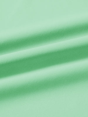 Fabric close-up of print collar quarter zip golf vest, smooth material with subtle texture in light green