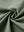 Close-up of quick dry casual dress pants fabric in olive green, smooth texture with breathable finish