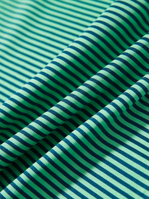 Close-up of green stripe performance cooling polo - youth fabric texture.