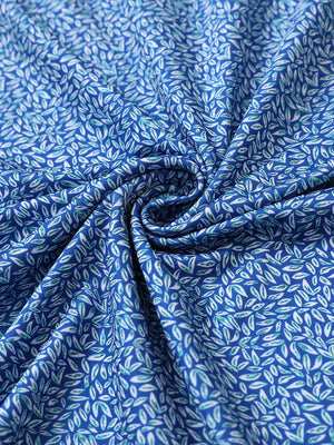 Close-up of blue small fish performance jersey print polo fabric texture.