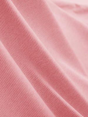 Fabric close-up of Premium Stretch Heather Polo showing crisp stripes and pink heather detail