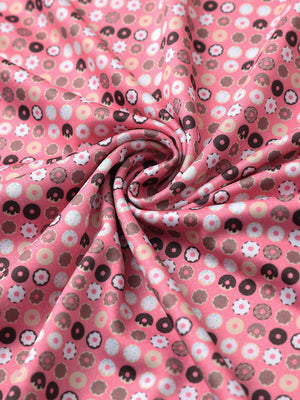 Close-up of pink donut golf performance print boys golf polo fabric showing moisture-wicking texture 