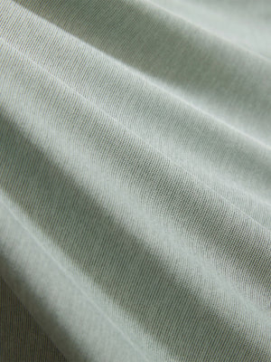 Close-up texture of grey green featherweight midlayer quarter zip pullover fabric showing detailed lightweight material and weave.